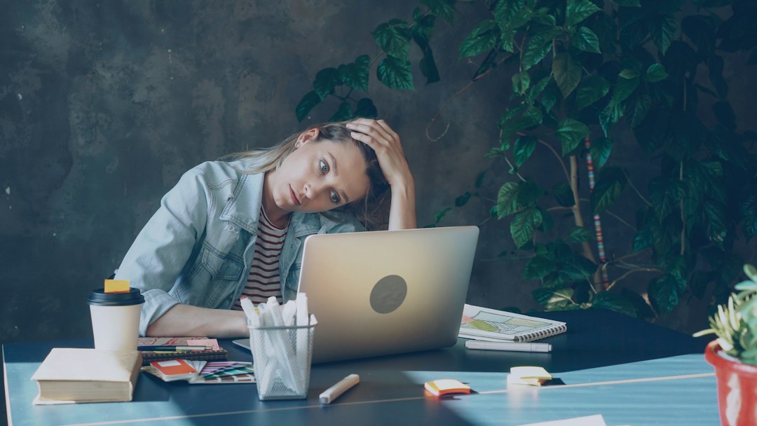 Woman sitting at her office computer, tired after a long workday